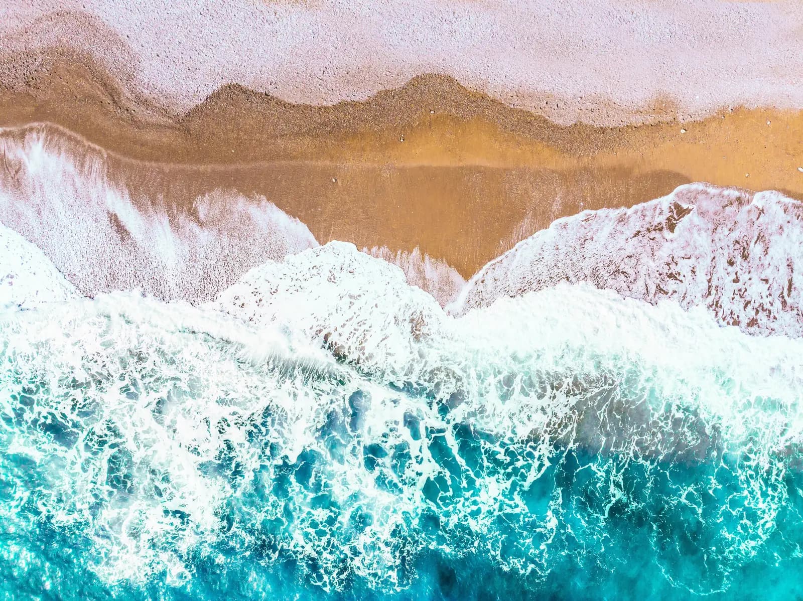 Aerial view of waves rolling onto the beach near Wrightsville Beach