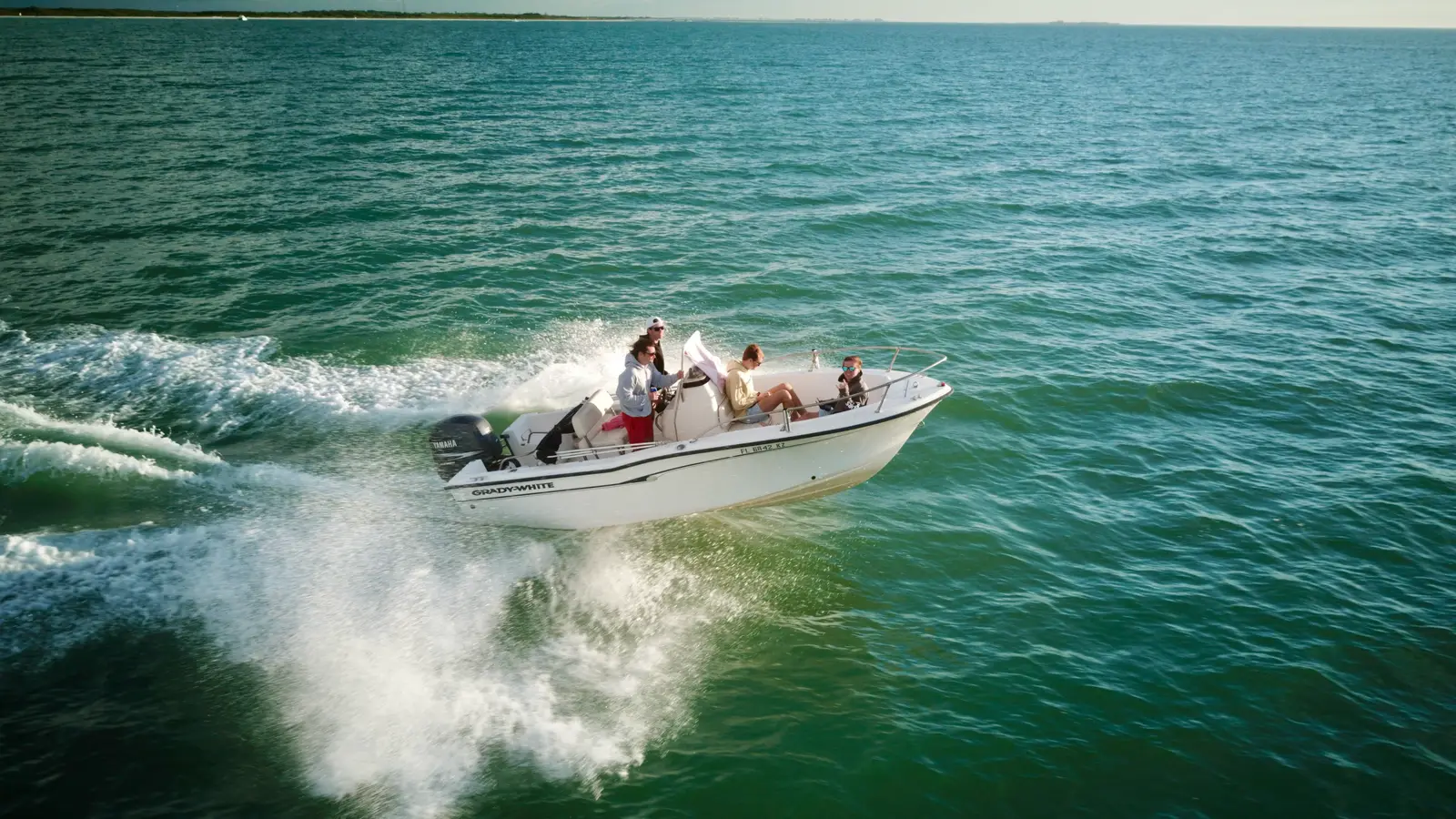 Guests riding a Grady-White boat across the water near Wrightsville Beach